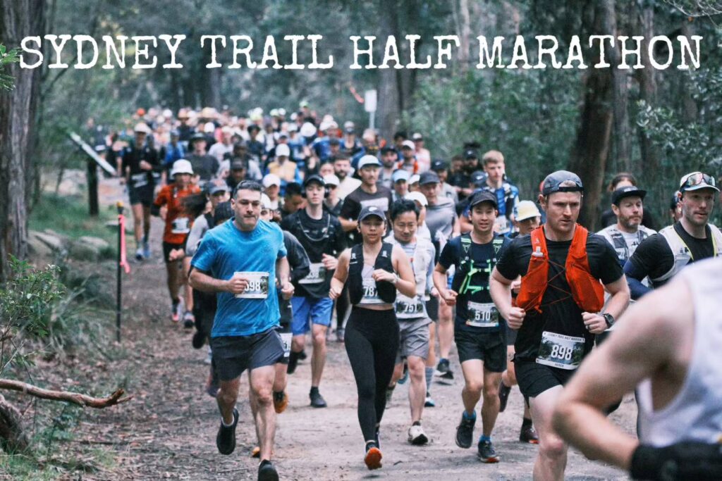 Trail runners starting the Sydney Trail Half Marathon 2025 through forest tracks at Lake Parramatta.